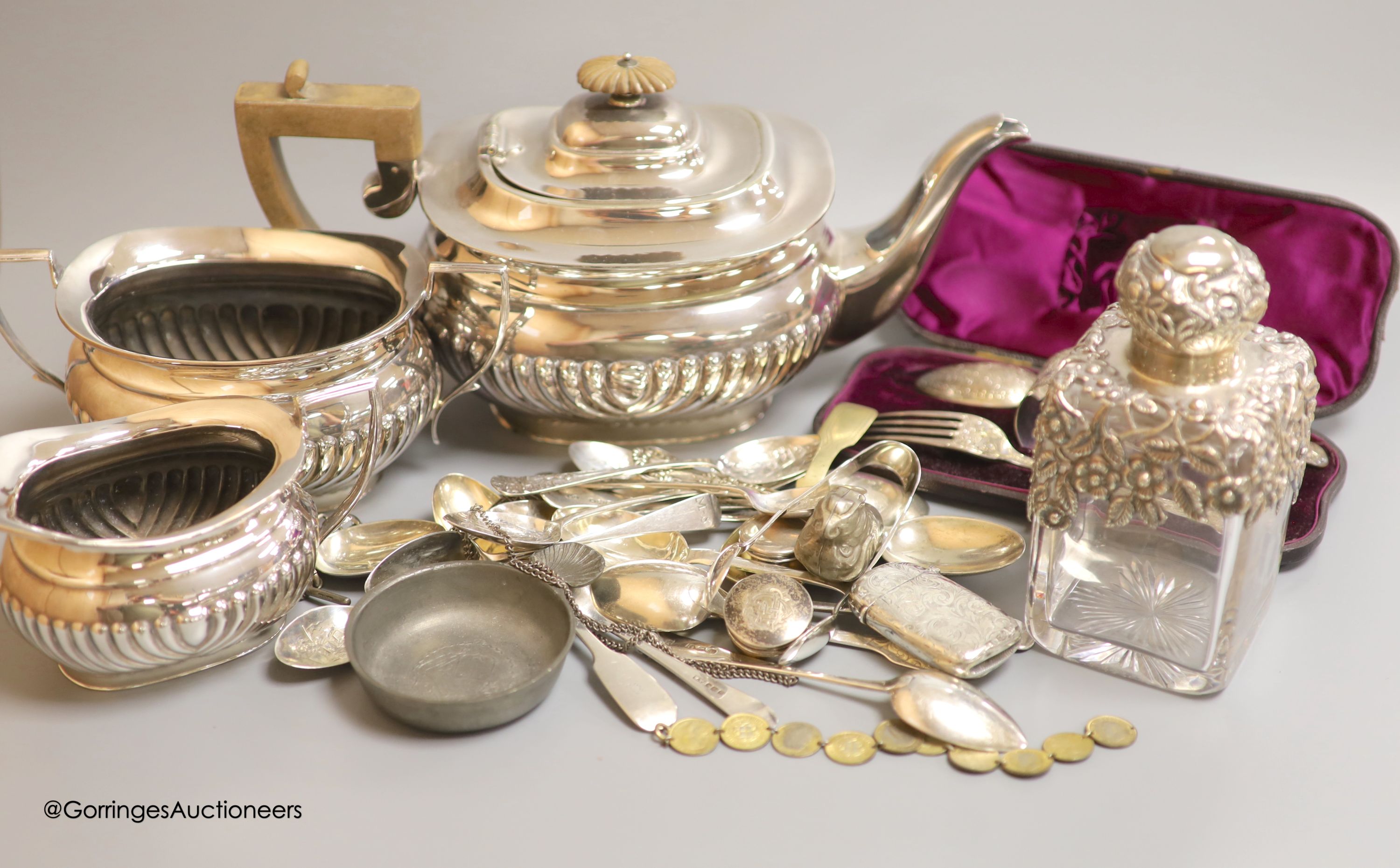 Assorted silver and plated wares including a silver mounted glass scent bottle, London, 1899, a similar cased christening trio, silver pill boxes, teaspoons and vesta case, plated tea set and minor items.